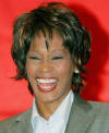 U.S. singer and actress Whitney Houston laughs during a news conference in Shanghai July 21, 2004. Houston will give a concert in Shanghai on Thursday as part of her China tour. 